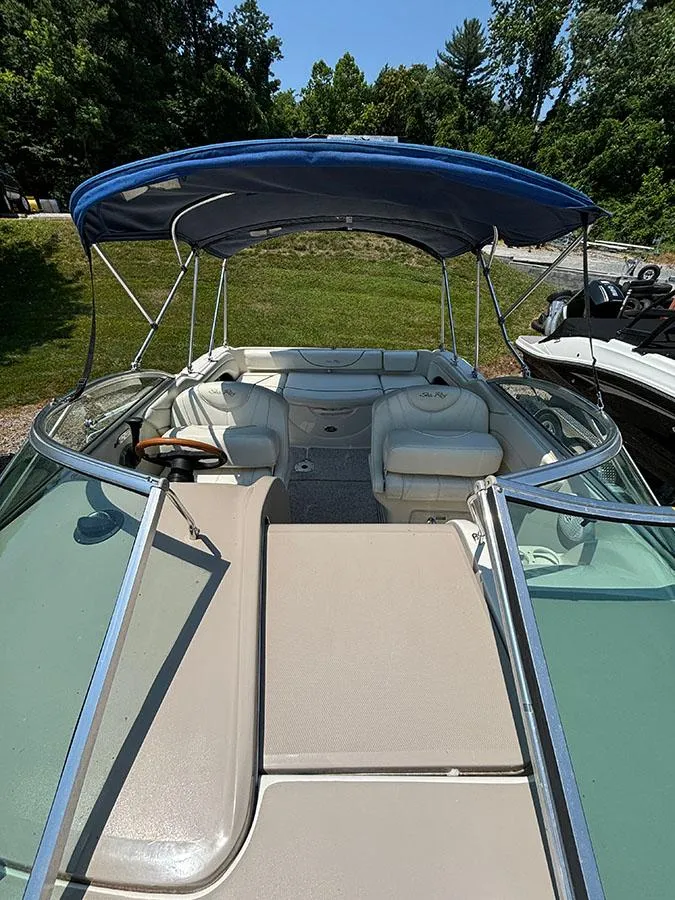 Slide: The Image of 2003 Sea Ray 225 Weekender boat with blue canopy and white seating. - 20