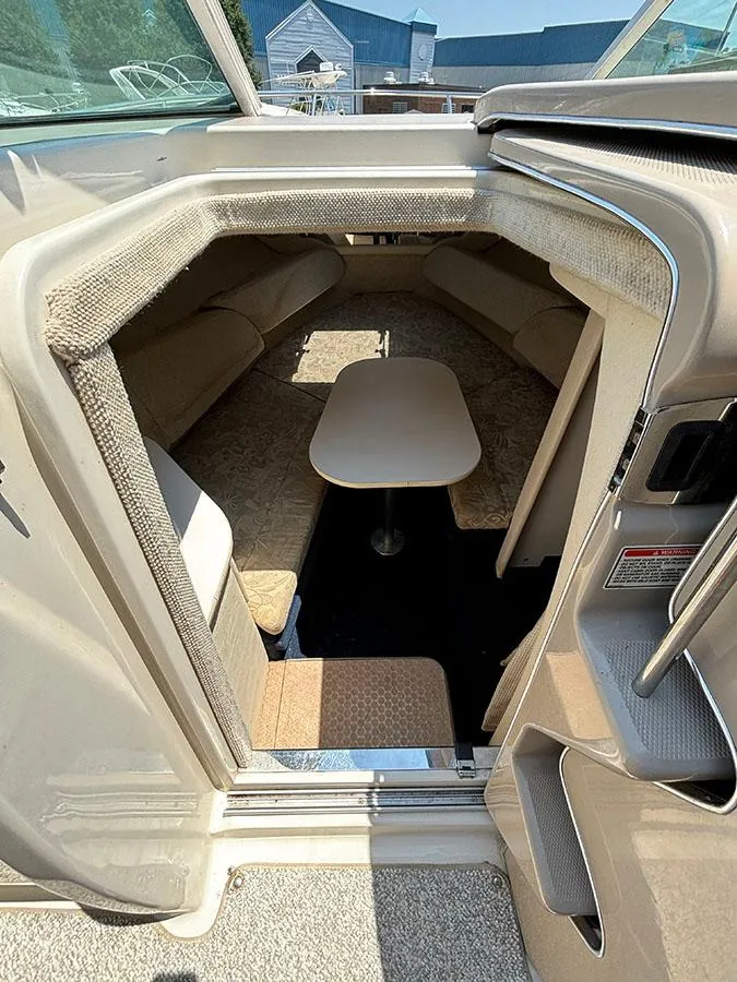 Slide: The Image of 2003 Sea Ray 225 Weekender cabin interior with seating and table. - 21