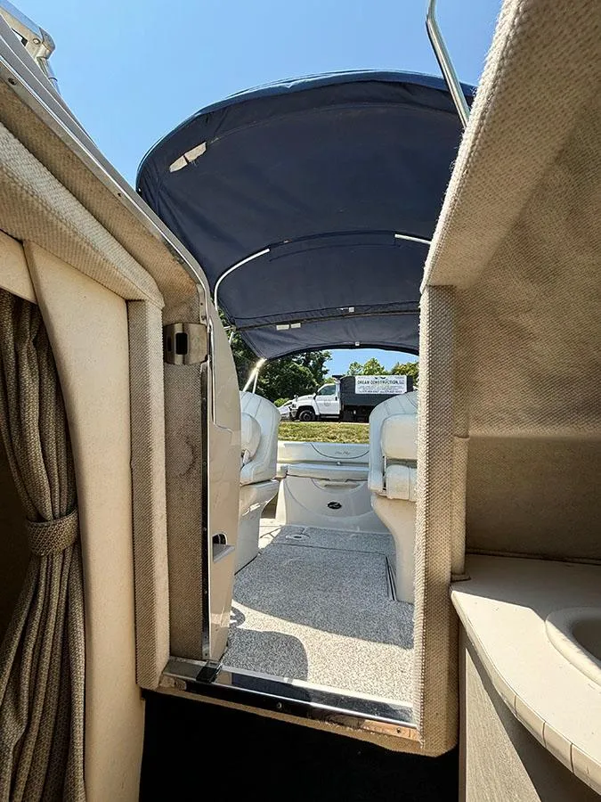Slide: The Image of 2003 Sea Ray 225 Weekender boat interior with canopy and seating area. - 26