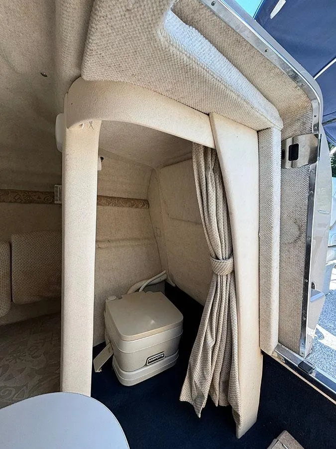 Slide: The Image of Interior cabin of a 2003 Sea Ray 225 Weekender boat with a portable toilet. - 27