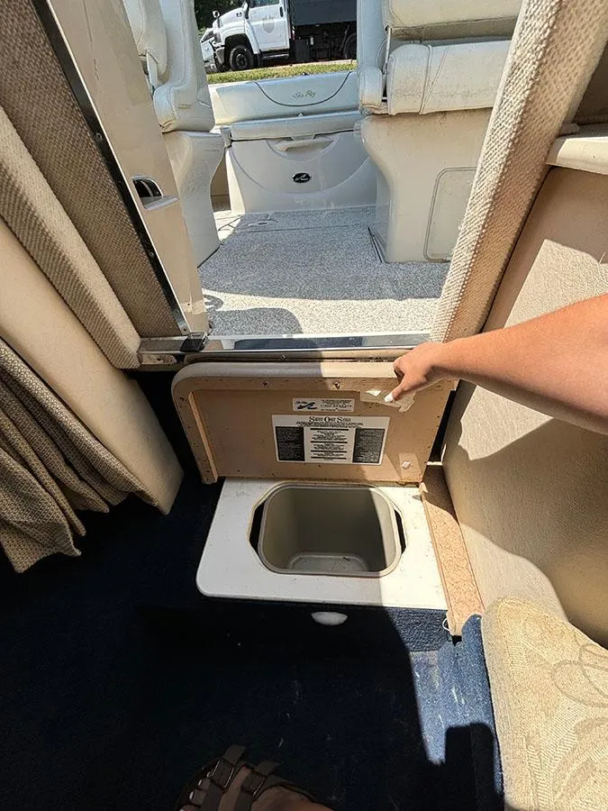 Slide: The Image of 2003 Sea Ray 225 Weekender interior storage compartment with hand opening hatch. - 28