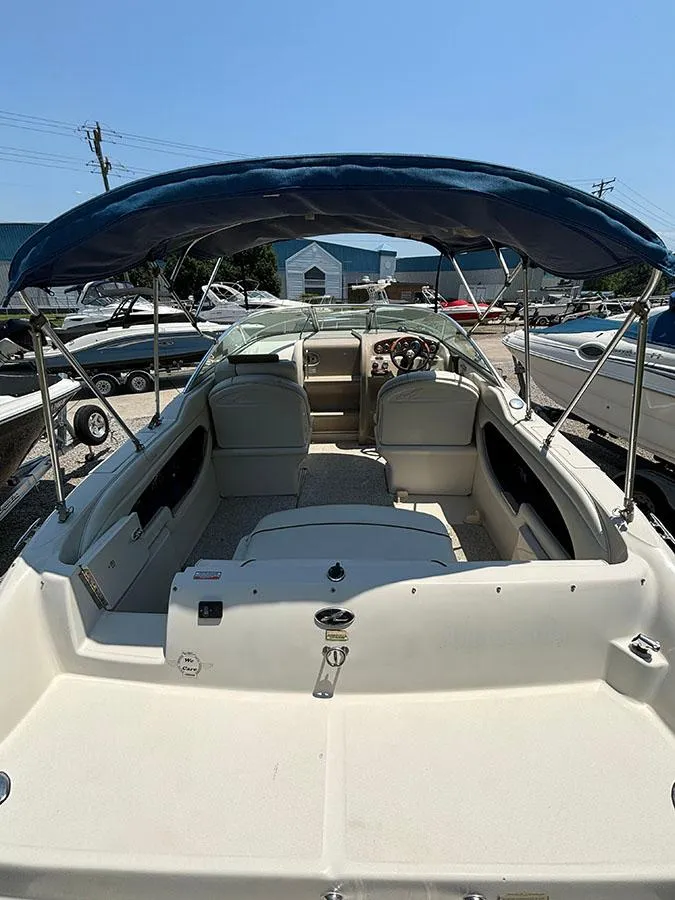 Slide: The Image of 2003 Sea Ray 225 Weekender boat with blue canopy and spacious seating. - 7