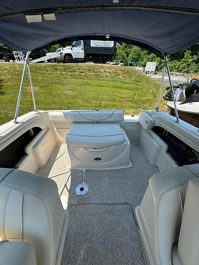 Slide: The Image of 2003 Sea Ray 225 Weekender boat interior with seating and canopy. - 8