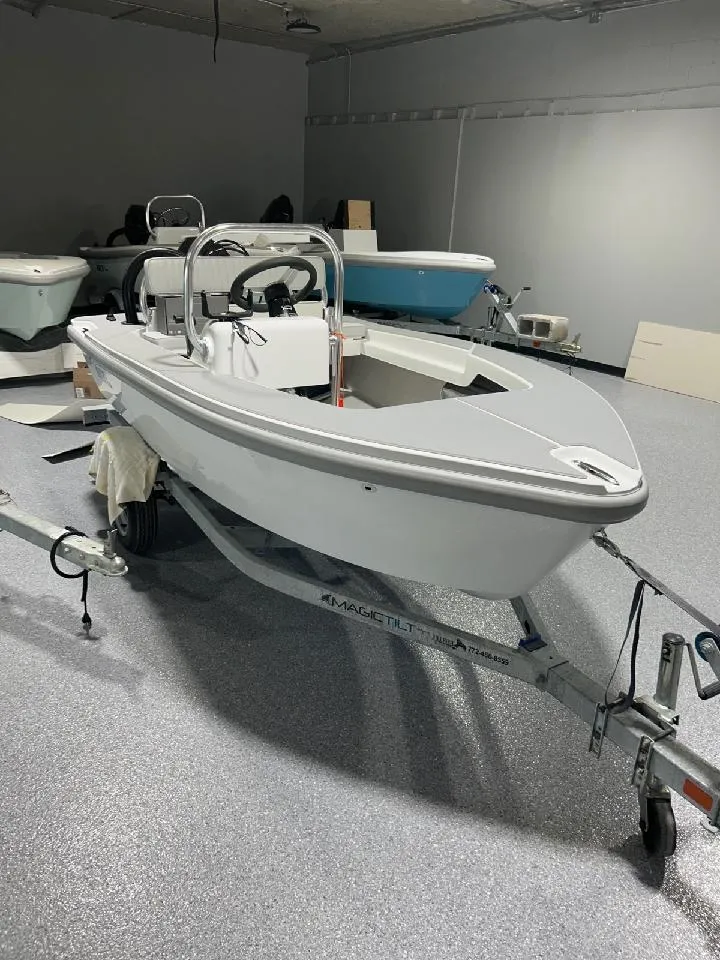 Slide: The Image of 2024 Ultra Lite Tenders Rigged 300 boat on trailer in showroom. - 0