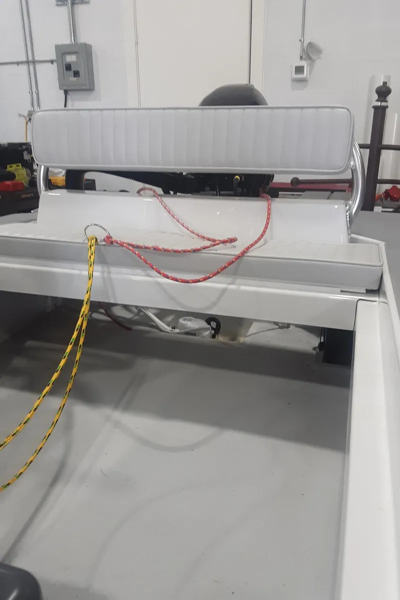 Slide: The Image of 2024 Ultra Lite Tenders Rigged 300 boat interior with seating and ropes. - 11
