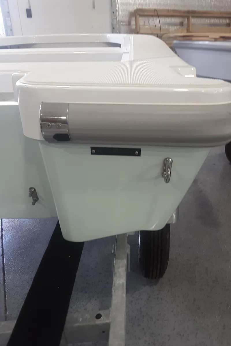 Slide: The Image of 2024 Ultra Lite Tenders Rigged 300 boat rear view in a showroom. - 16