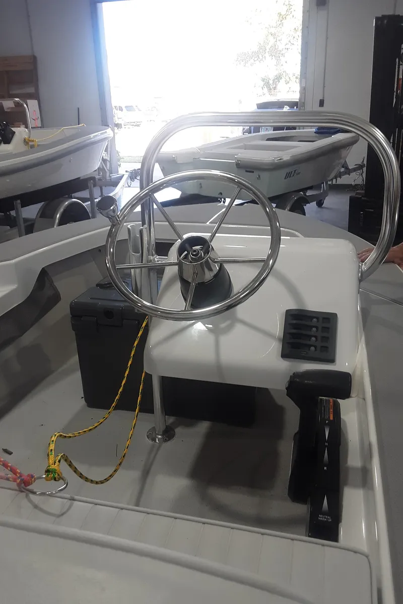 Slide: The Image of 2024 Ultra Lite Tenders Rigged 300 boat steering console in showroom. - 3
