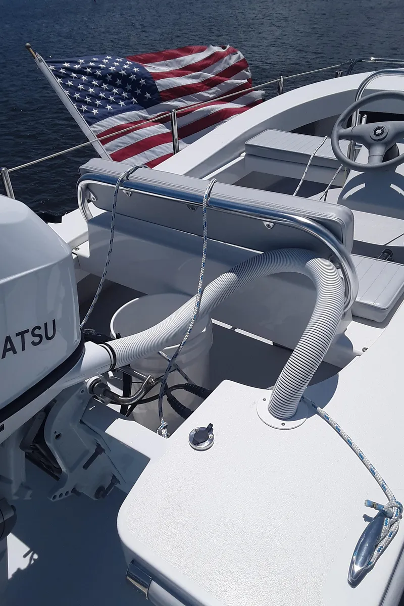 Slide: The Image of 2024 Ultra Lite Tenders Rigged 300 boat with American flag and Tatsu engine. - 7