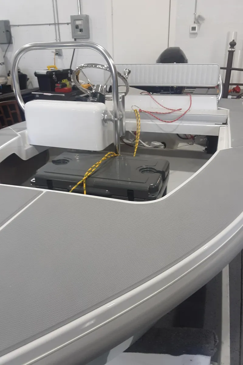 Slide: The Image of 2024 Ultra Lite Tenders Rigged 300 boat interior with seating and control console. - 9
