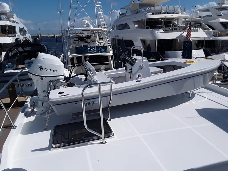 Slide: The Image of 2024 Ultra Lite Tenders Rigged 380 boat docked among luxury yachts. - 1