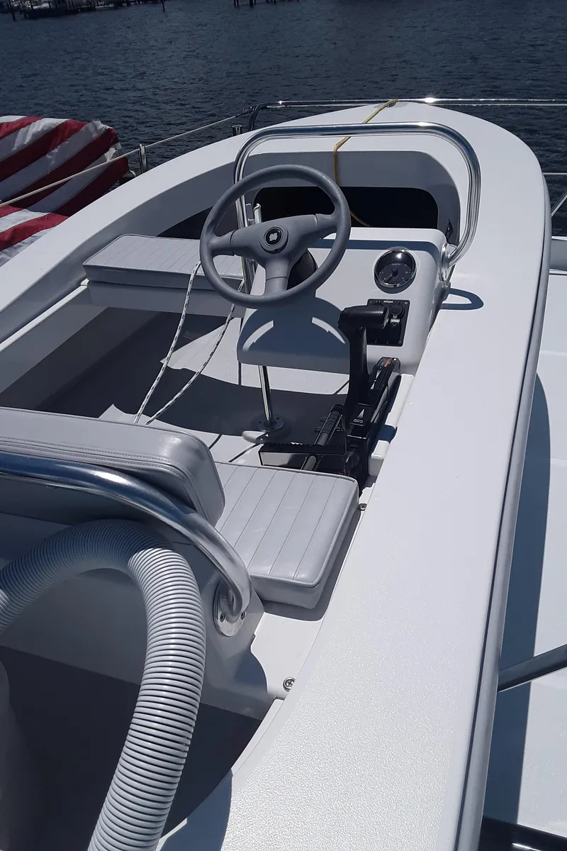 Slide: The Image of 2024 Ultra Lite Tenders Rigged 380 boat interior with steering wheel and seating. - 10