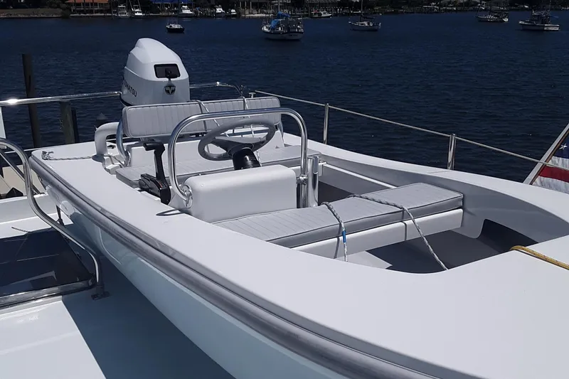 Slide: The Image of 2024 Ultra Lite Tenders Rigged 380 boat docked with scenic water view. - 11