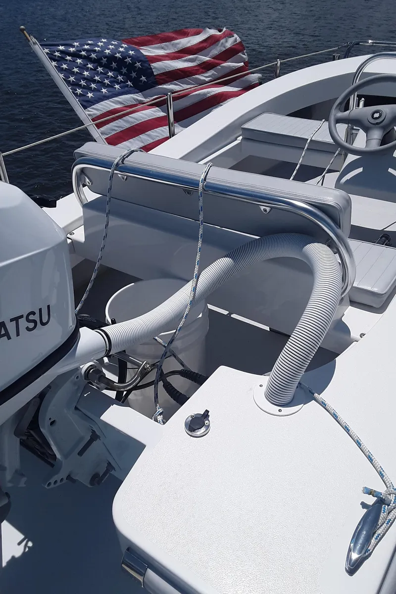 Slide: The Image of 2024 Ultra Lite Tenders Rigged 380 boat with American flag and Tohatsu engine. - 6