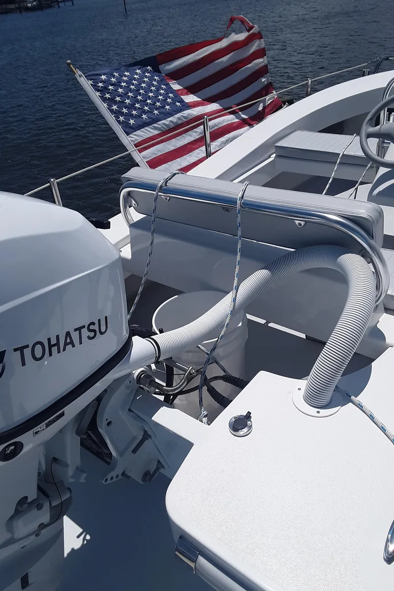 Slide: The Image of 2024 Ultra Lite Tenders Rigged 380 boat with Tohatsu engine and American flag. - 7