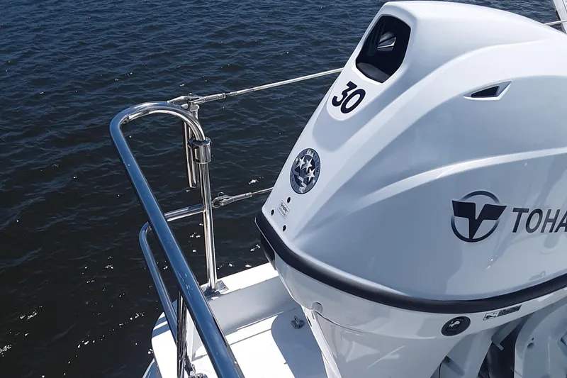 Slide: The Image of Ultra Lite Tenders Rigged 380, 2024 model, with Tohatsu outboard motor on water. - 8