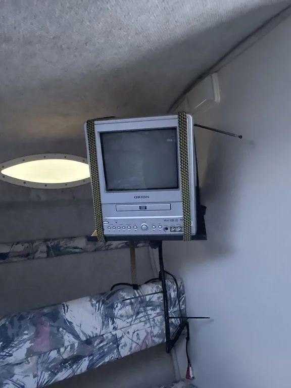 Slide: The Image of 1998 Sea Ray 240 Sundancer cockpit with white seating and steering wheel. - 12