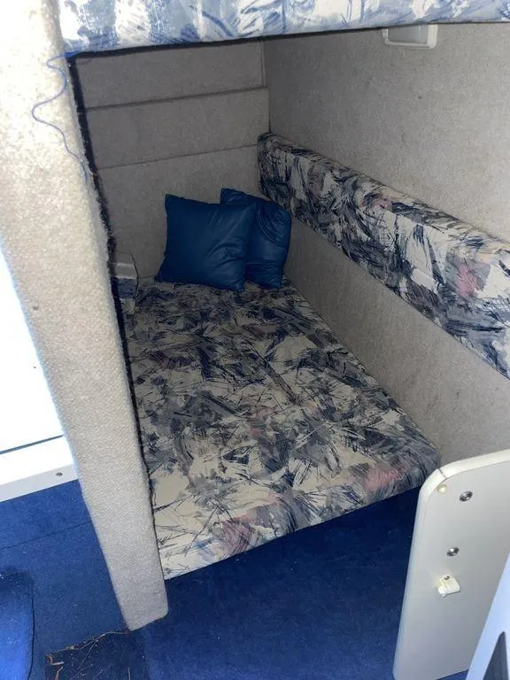 Slide: The Image of 1998 Sea Ray 240 Sundancer helm with steering wheel and control panel. - 17