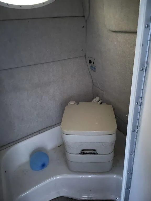 Slide: The Image of 1998 Sea Ray 240 Sundancer cabin interior with kitchenette and seating area. - 18