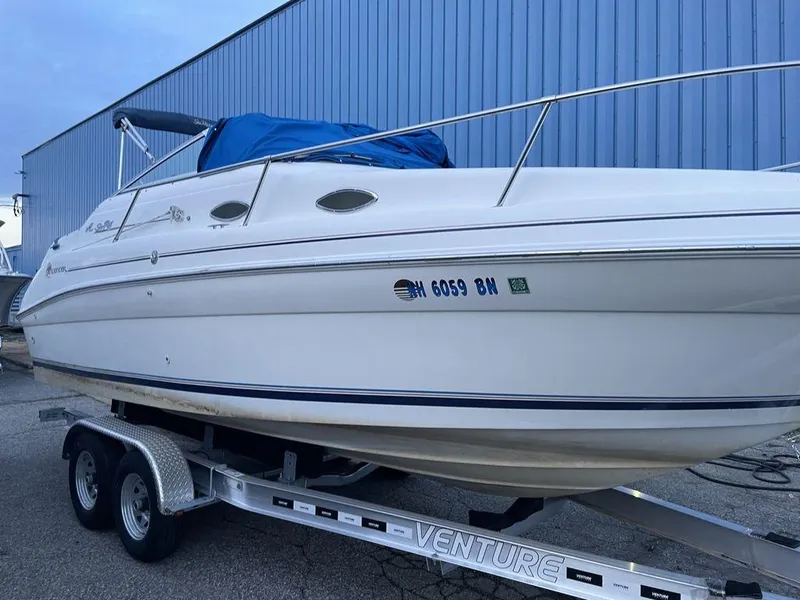 Slide: The Image of 1998 Sea Ray 240 Sundancer boat on trailer under clear blue sky. - 2
