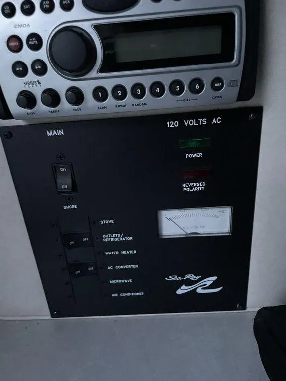 Slide: The Image of Interior of 1998 Sea Ray 240 Sundancer boat with TV, sink, and seating area. - 21