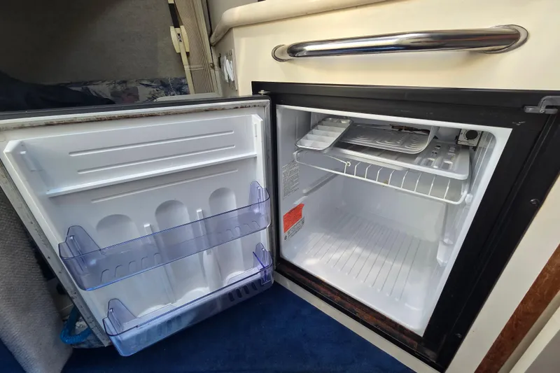 Slide: The Image of Open mini fridge inside 1998 Sea Ray 240 Sundancer boat cabin. - 25