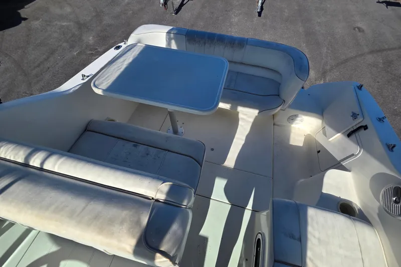 Slide: The Image of 1998 Sea Ray 240 Sundancer boat interior with seating and table. - 27