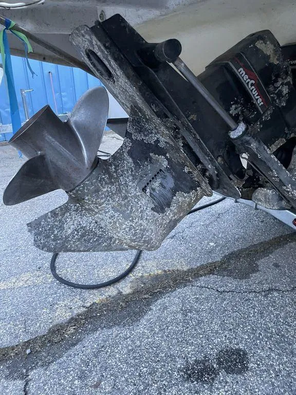 Slide: The Image of 1998 Sea Ray 240 Sundancer boat on trailer, parked outdoors under clear blue sky. - 4