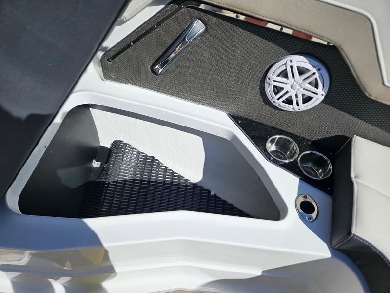 Slide: The Image of 2025 Monterey 275SS boat interior with speaker, cup holders, and storage compartment. - 28