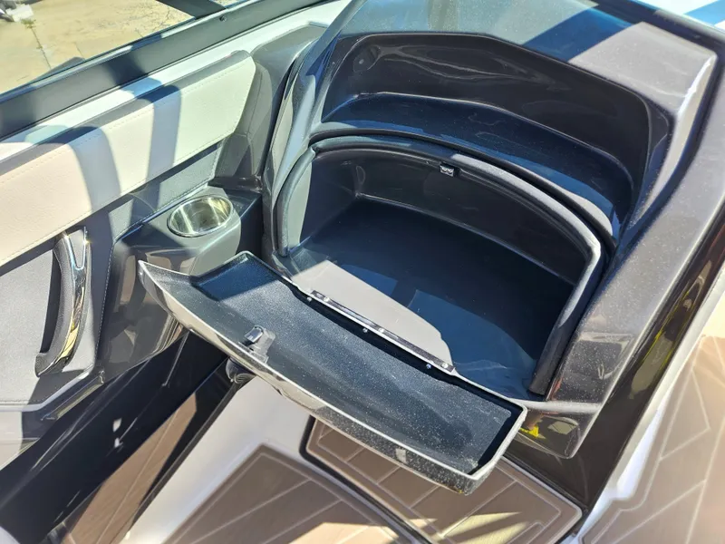 Slide: The Image of 2025 Monterey 275SS boat storage compartment and cup holder. - 31