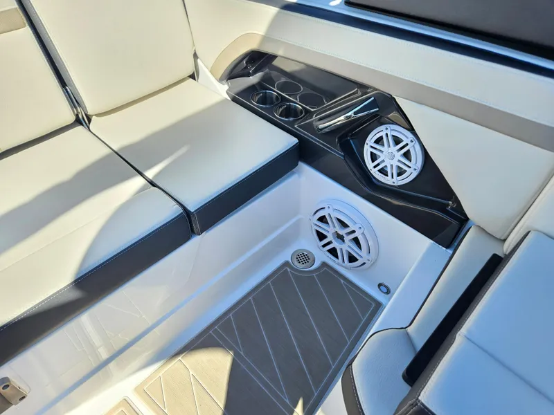 Slide: The Image of 2025 Monterey 275SS boat interior with seating, cup holders, and speakers. - 32