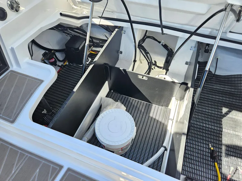 Slide: The Image of 2025 Monterey 275SS boat engine compartment with storage and wiring. - 38