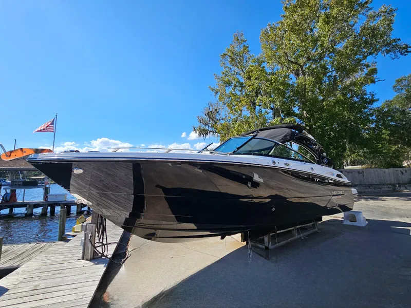Slide: The Image of 2025 Monterey 275SS boat docked near a marina on a sunny day. - 39
