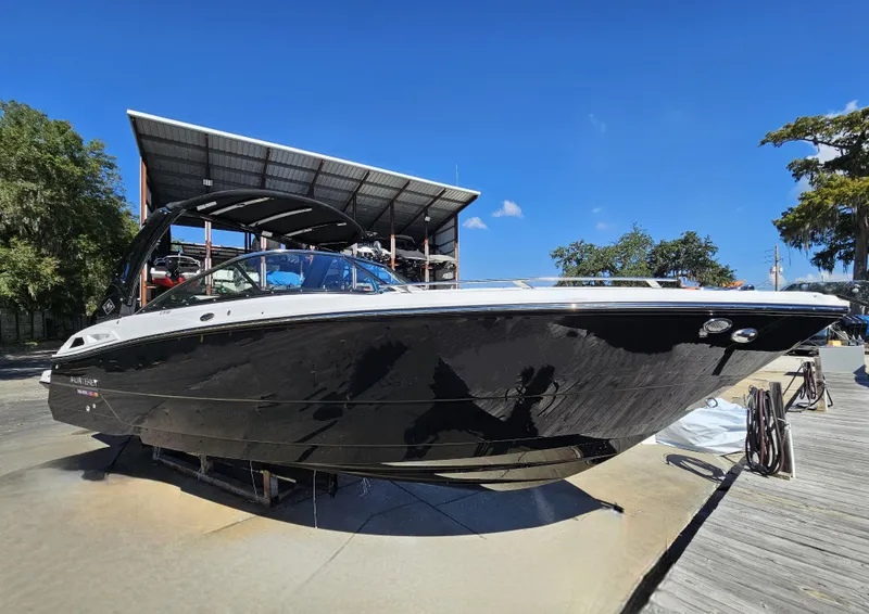 Slide: The Image of 2025 Monterey 275SS boat docked under clear blue sky. - 7