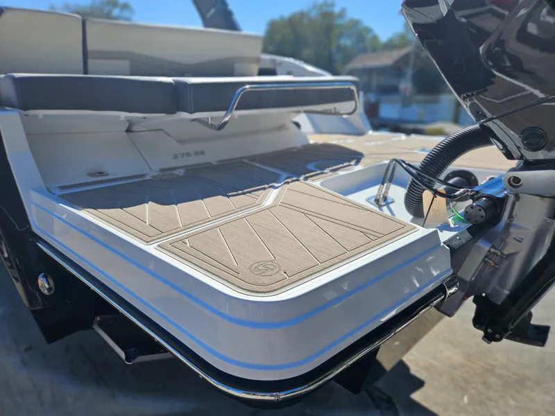 Slide: The Image of 2025 Monterey 275SS boat with a spacious swim platform and cushioned seating. - 8