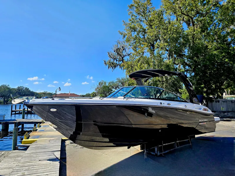 Slide: The Image of 2025 Monterey 275SS boat docked by a lake on a sunny day. - 1