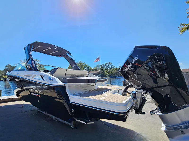 Slide: The Image of 2025 Monterey 275SS boat with Mercury outboard motor docked by the water. - 9