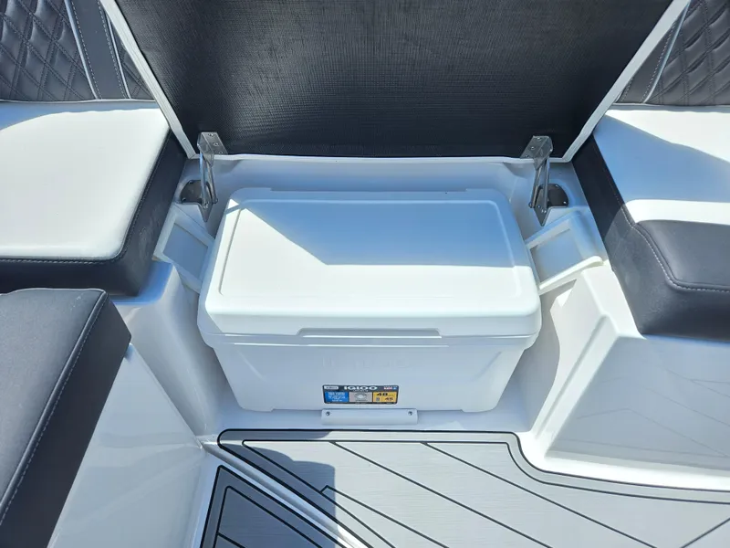Slide: The Image of Cooler storage area on a 2025 Monterey M-65 boat with cushioned seating. - 13