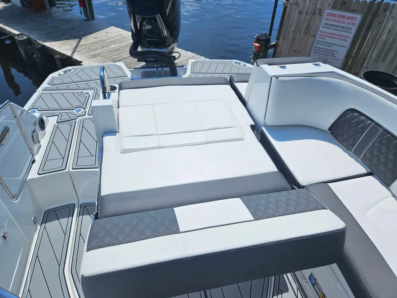 Slide: The Image of 2025 Monterey M-65 boat interior with sleek seating and modern design by the water. - 16