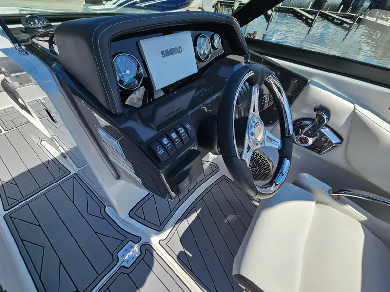 Slide: The Image of 2025 Monterey M-65 boat cockpit with modern steering and control panel. - 23