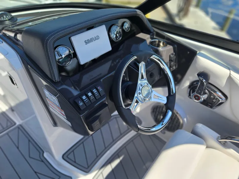 Slide: The Image of Steering console of 2025 Monterey M-65 boat with Simrad display and controls. - 24