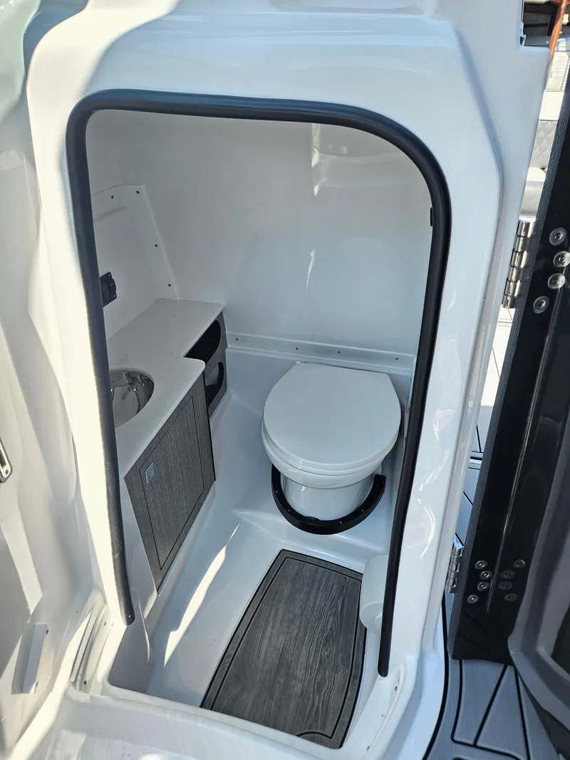 Slide: The Image of Compact bathroom in 2025 Monterey M-65 boat, featuring modern design and amenities. - 29
