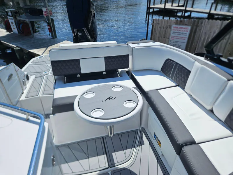 Slide: The Image of Luxury seating area on a 2025 Monterey M-65 boat, featuring a stylish round table. - 35