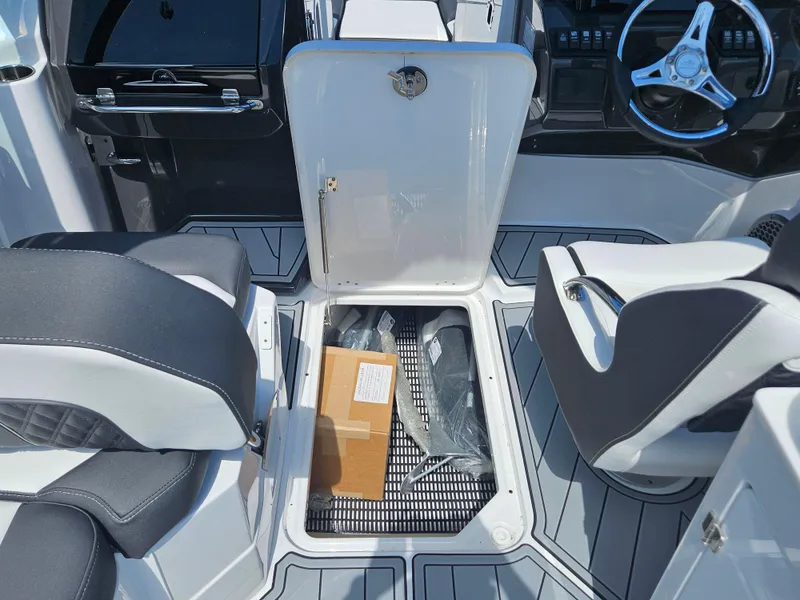 Slide: The Image of Interior of 2025 Monterey M-65 boat showing storage compartment and seating area. - 37