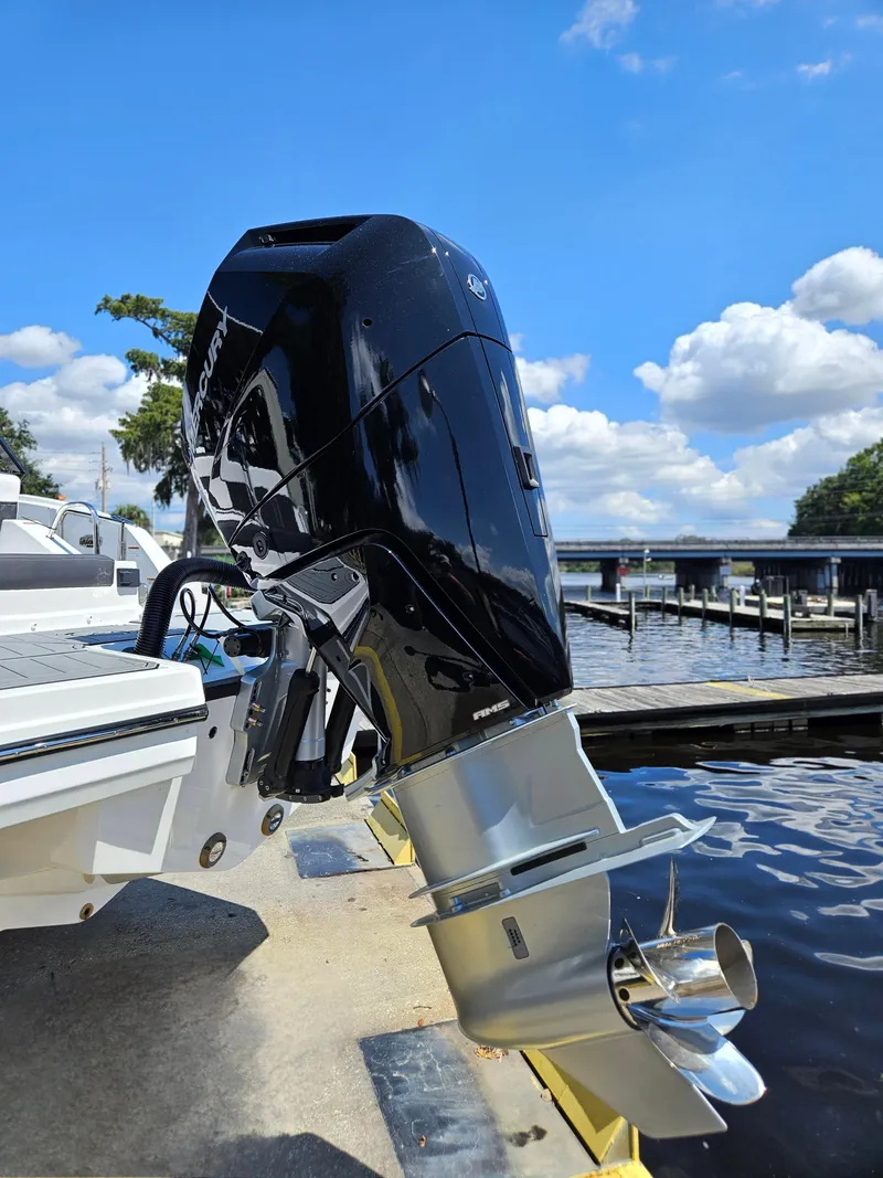 Slide: The Image of Outboard motor of 2025 Monterey M-65 boat docked by a sunny waterfront. - 5