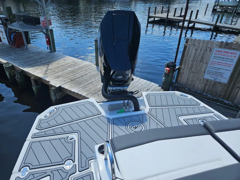 Slide: The Image of Monterey M-65 boat at dock, showcasing sleek design and powerful engine, 2025 model. - 8