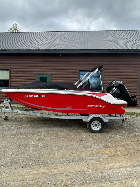 Slide: The Image of 2023 Bayliner 170 EL boat in red, parked on a trailer. - 1