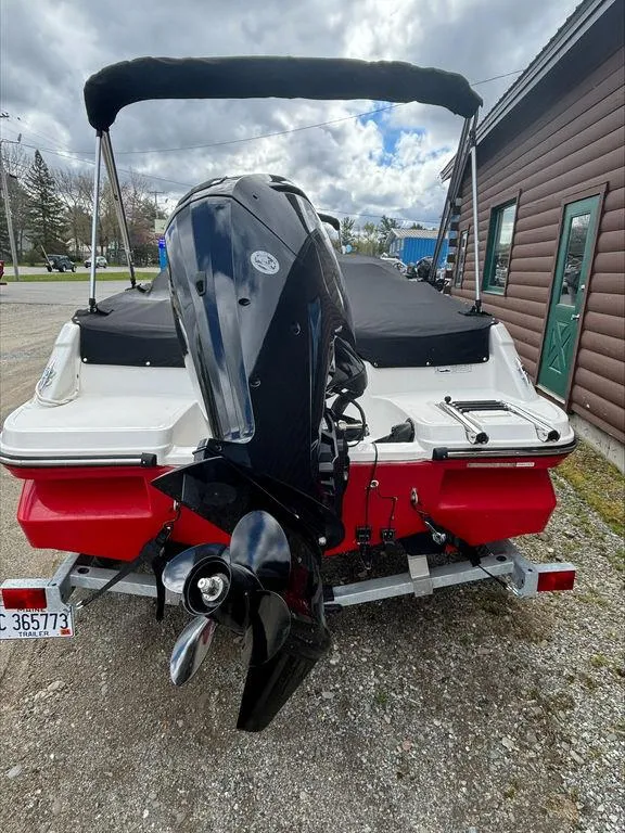 Slide: The Image of 2023 Bayliner 170 EL boat with outboard motor, red and white hull, on trailer. - 3