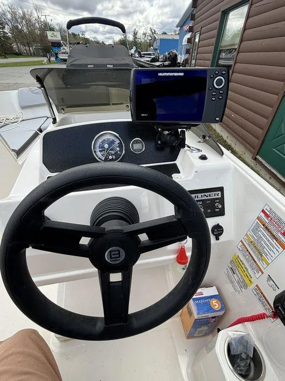 Slide: The Image of 2023 Bayliner 170 EL boat dashboard with steering wheel and navigation system. - 4