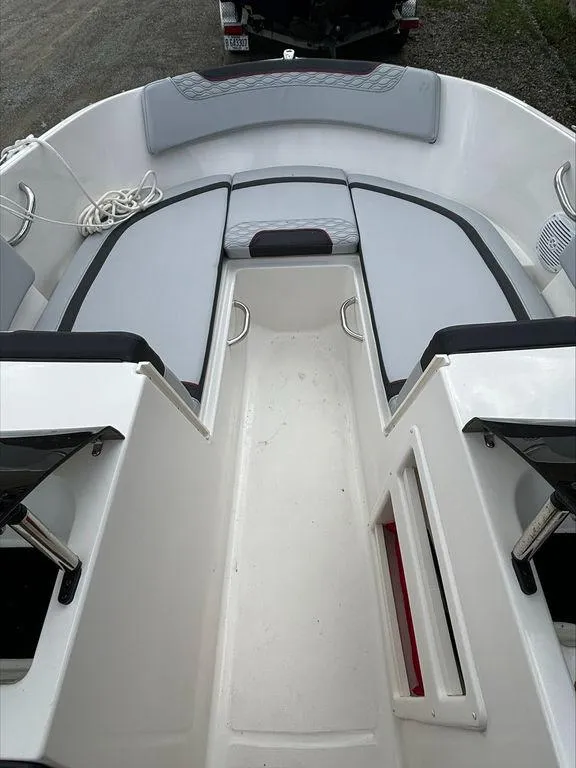 Slide: The Image of 2023 Bayliner 170 EL boat interior with seating and storage compartments. - 8