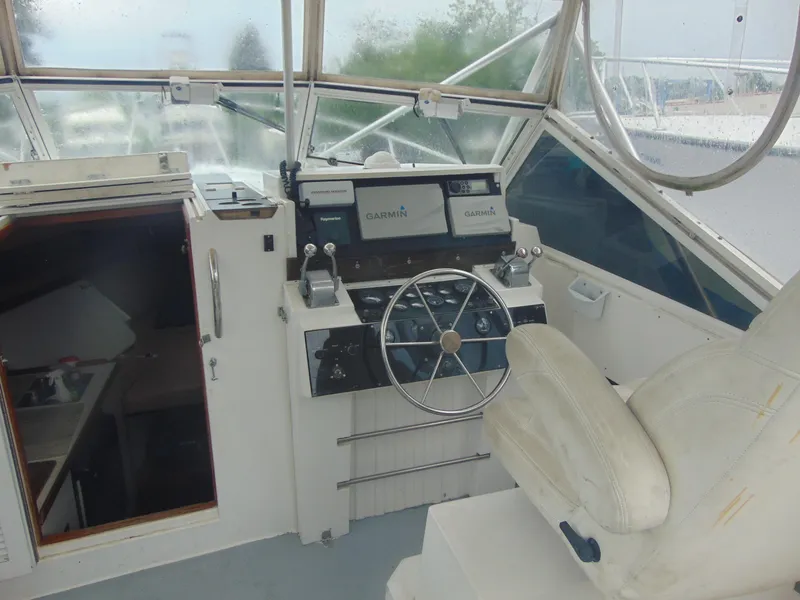 Slide: The Image of 1987 Black Watch Sportfish boat cockpit with steering wheel and navigation equipment. - 4